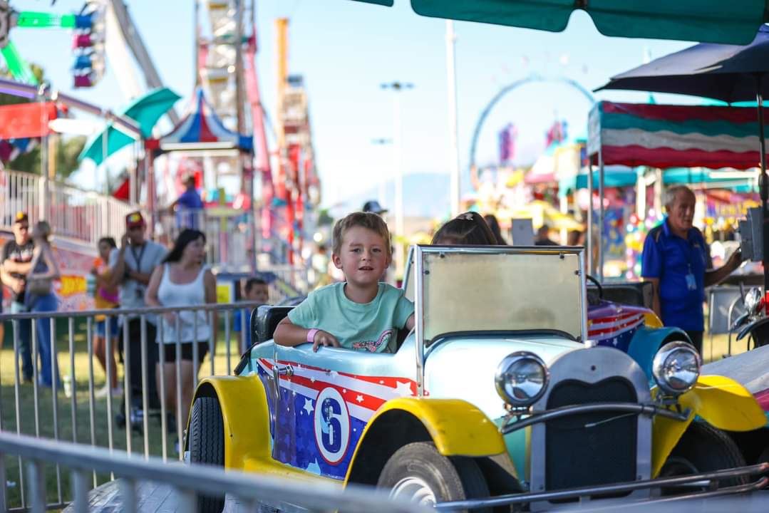 Kids sitting in Roadsters car while it rides