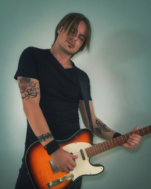 Man who looks like Keith Urban with a guitar