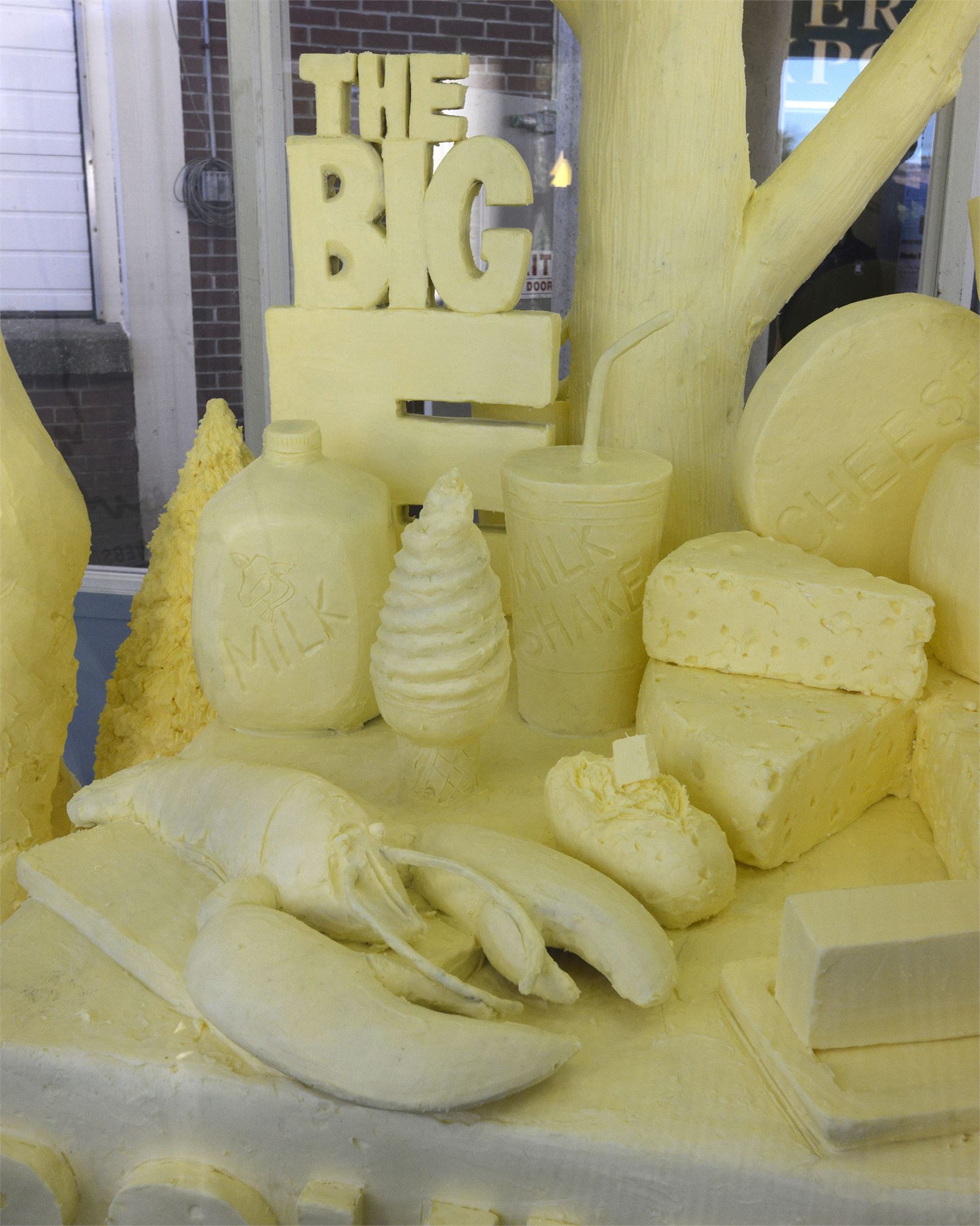 A detailed sculpture made from butter of a 600 pound man eating a