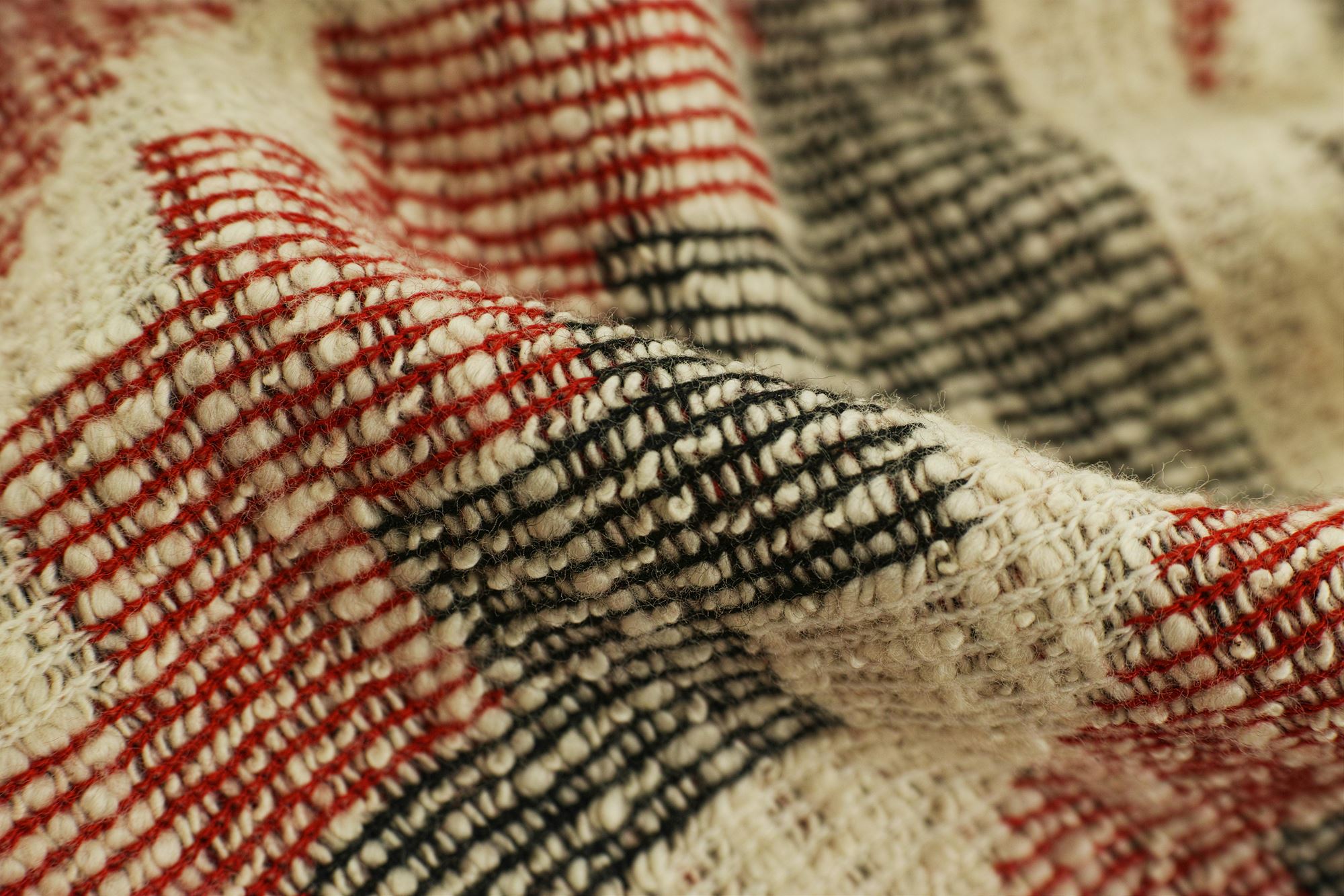 Red, green and cream colored knit blanket