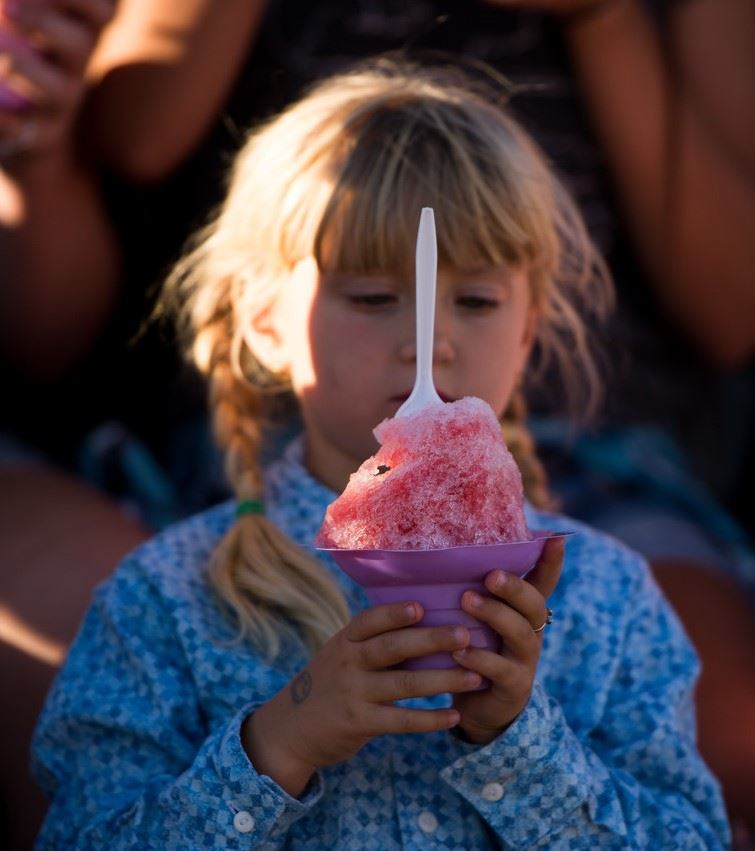 Photo: Young girl holding a cone full of shaved ice