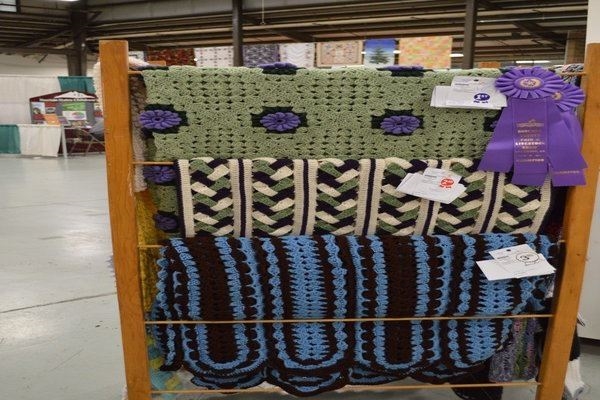 Colorful knitted blankets on display in Exhibit Building 