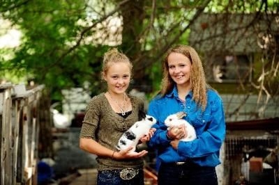 Two 4-H girls holding rabbits