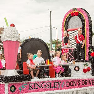Children from Kingsley School on a float designed as Don's Drive In