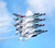 Five USA Thunderbirds flying in a tight formation