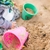 Child playing with buckets in the sand