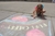 Young girl drawing with chalk on the sidewalk