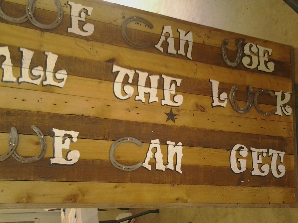 old bed slats, old tomato stakes, and old horseshoes make this awesome sign.