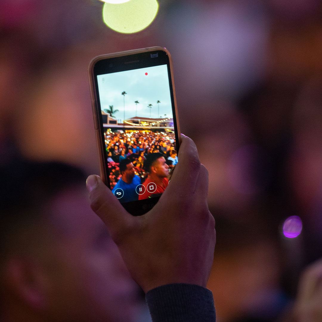 Cell phone taking photo of concert