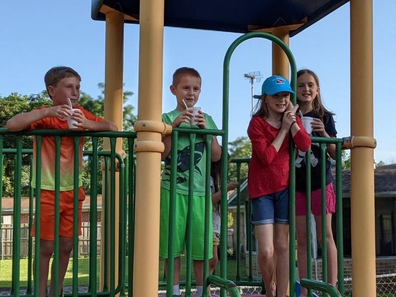 4 children on playground structure 