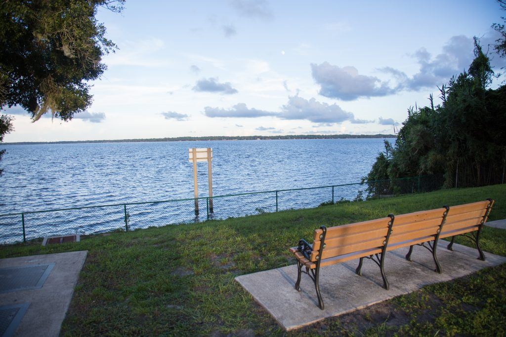 Park bench with a grassy area  facing St. Johns River at Kingsley East River Overlook