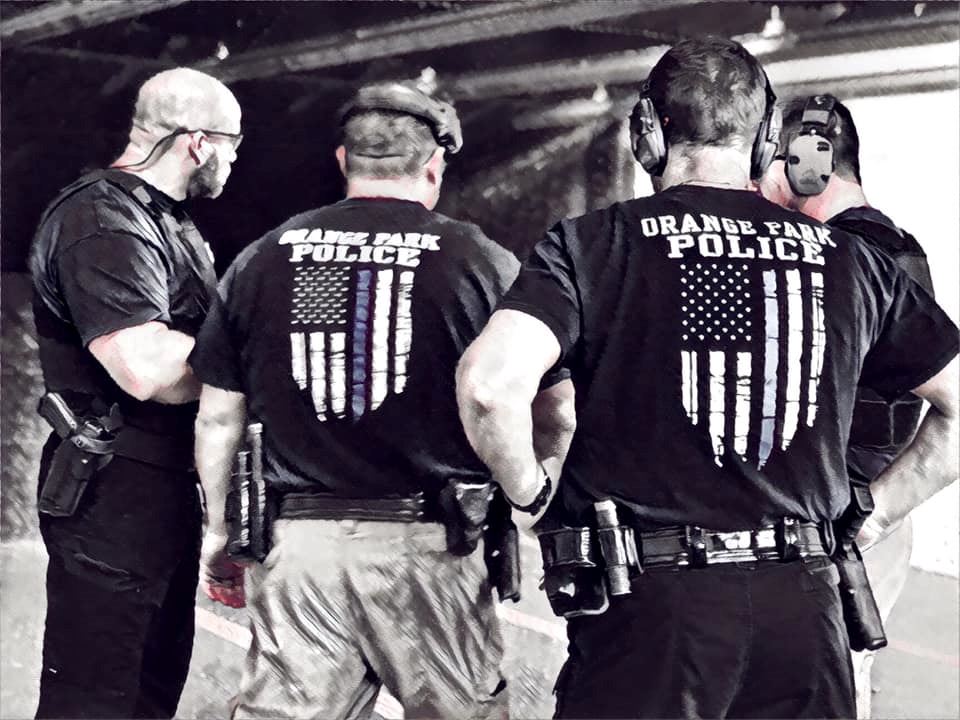 Group of police officers view of their backs.