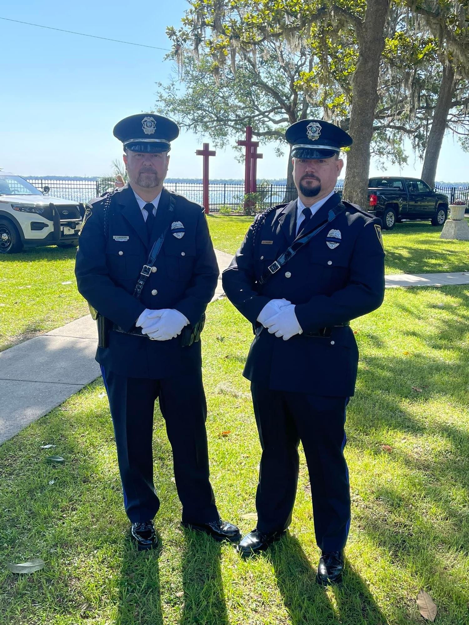 2 officers in dress uniform on a sunny day