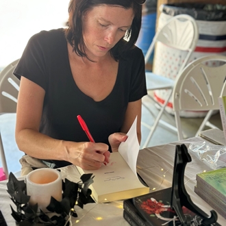 Author signing in Fiddlers Grove Photo by Toshya DeRossett